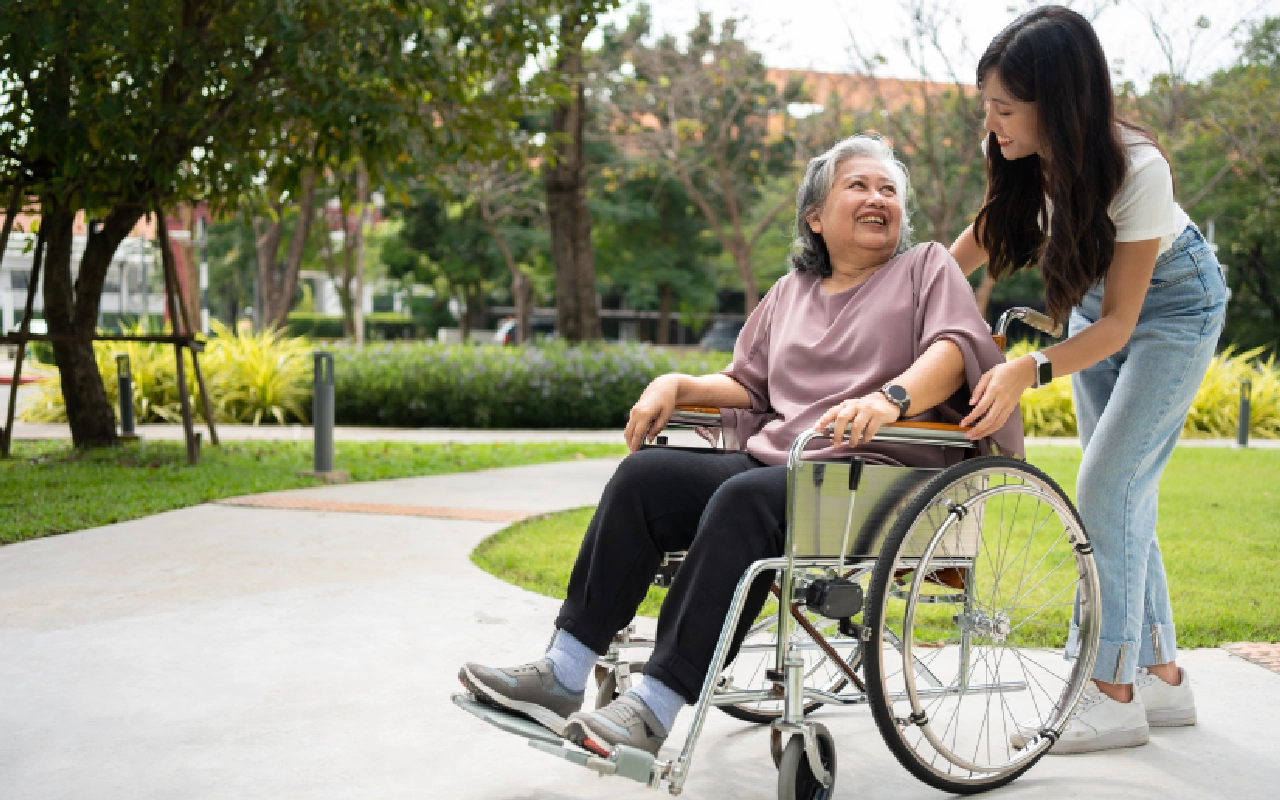 A woman in a wheelchair with an older person.